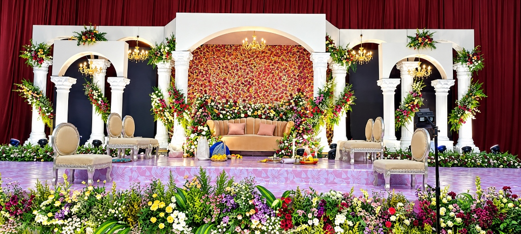 Jaya Media grand luxury wedding mandap stage with floral archways and chandeliers